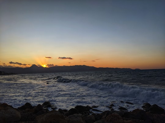 sea waves crashing on rocks during sunset in Kissamos Greece