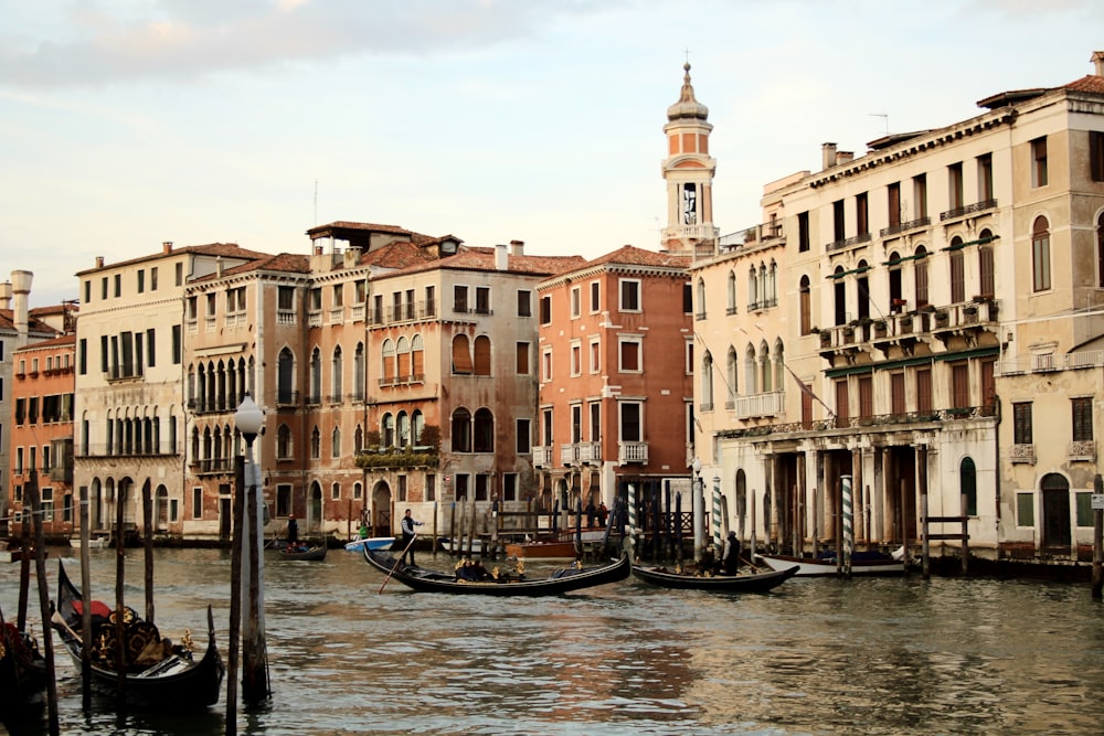 boat on river between buildings during daytime