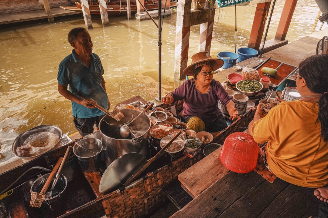 woman in blue shirt cooking on brown wooden table,