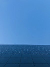 blue sky over black and white concrete building