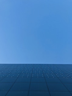 blue sky over black and white concrete building