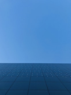 blue sky over black and white concrete building