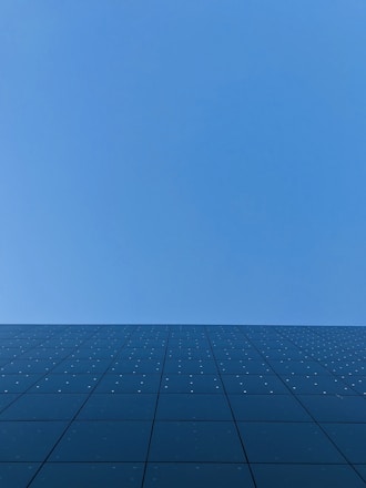 blue sky over black and white concrete building