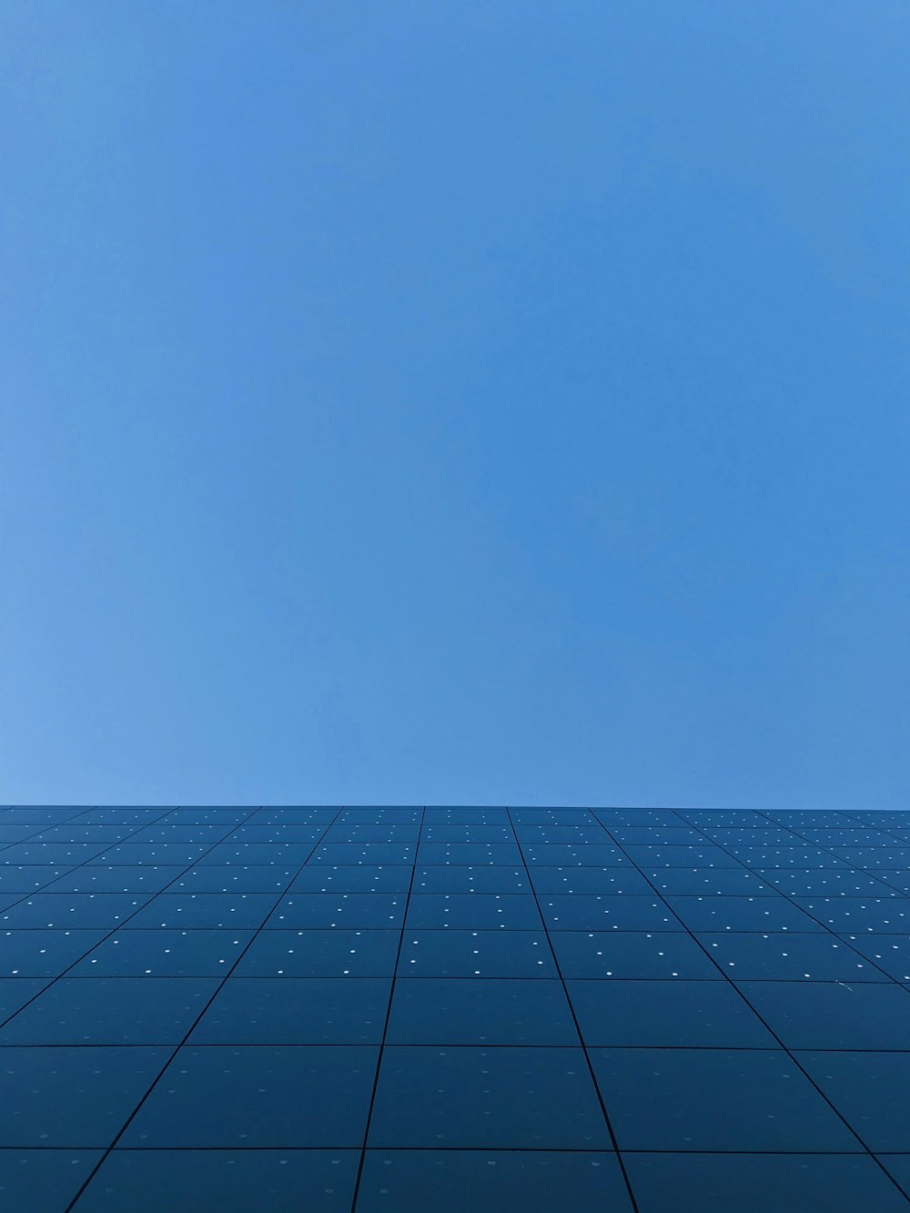 blue sky over black and white concrete building