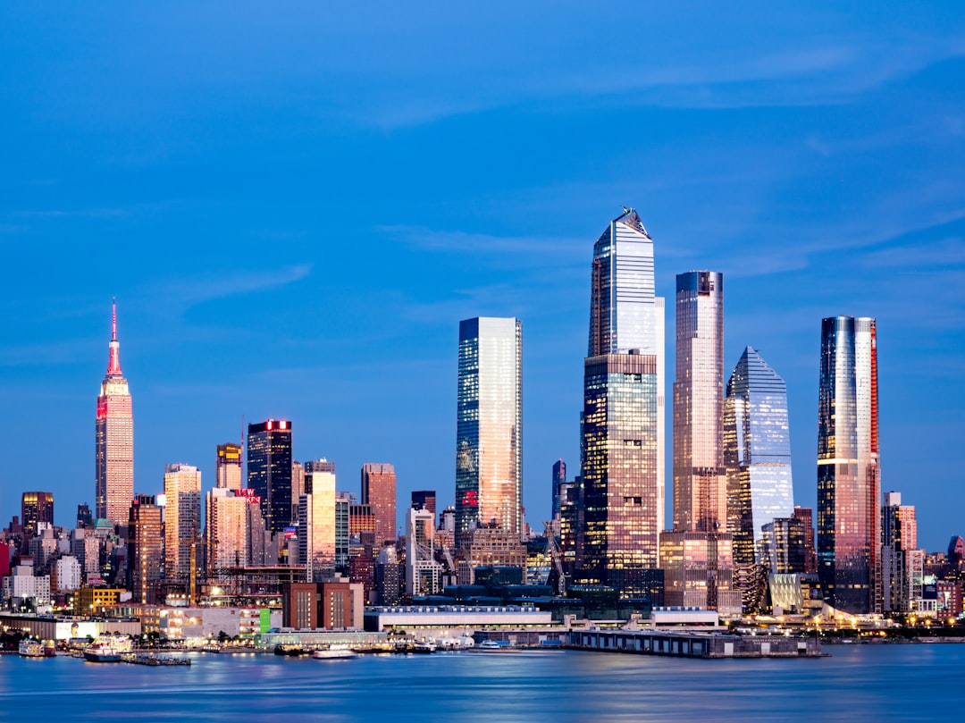 city skyline across body of water during daytime