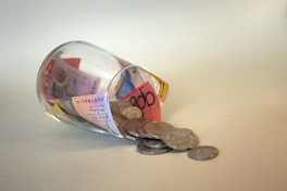 coins and coins in clear glass jar