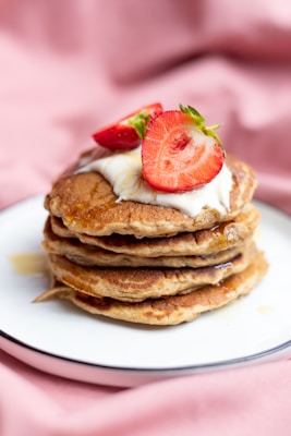 pancakes with strawberry on white ceramic plate
