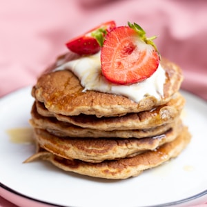 pancakes with strawberry on white ceramic plate