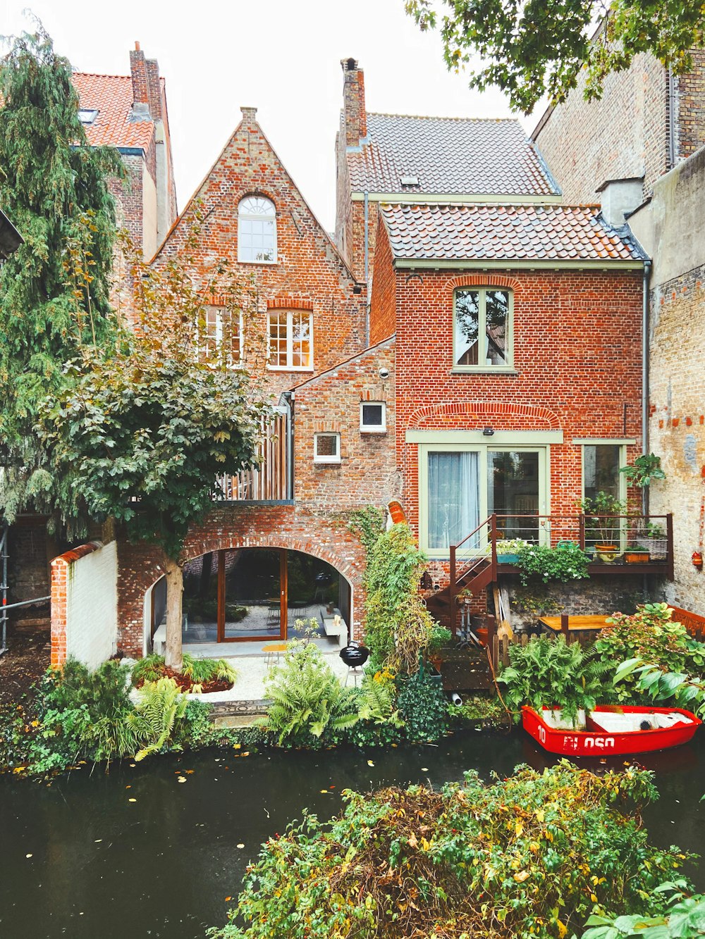 red boat on water near brown brick building during daytime