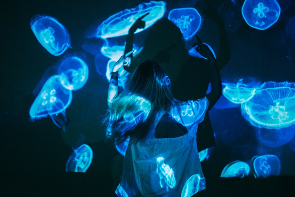 woman in white and black dress with blue and white lights