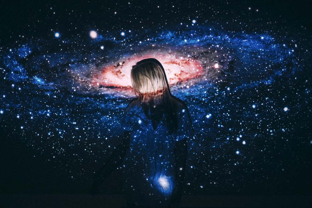 femme en veste en cuir noir regardant des étoiles