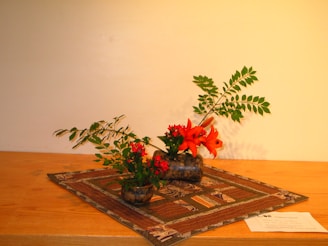 A close-up of a tasteful arrangement of fresh flowers and a handwritten note on a polished wooden table.