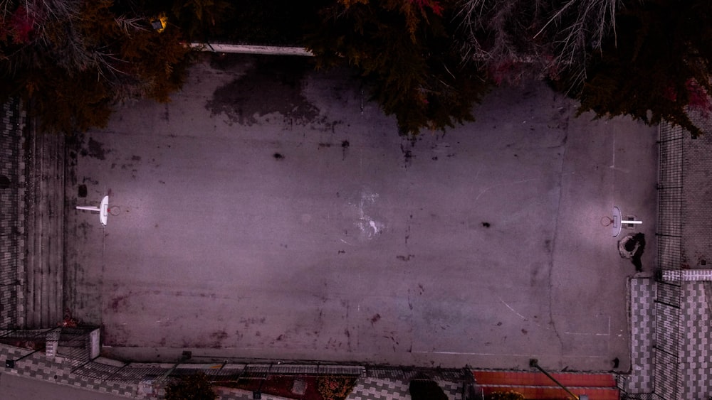 a concrete wall with a red bench in front of it