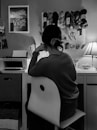 woman in black and white long sleeve shirt using computer