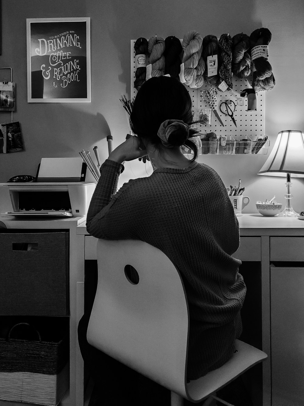 woman in black and white long sleeve shirt using computer