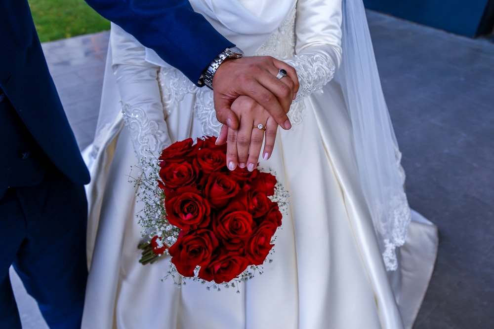 man and woman holding red roses