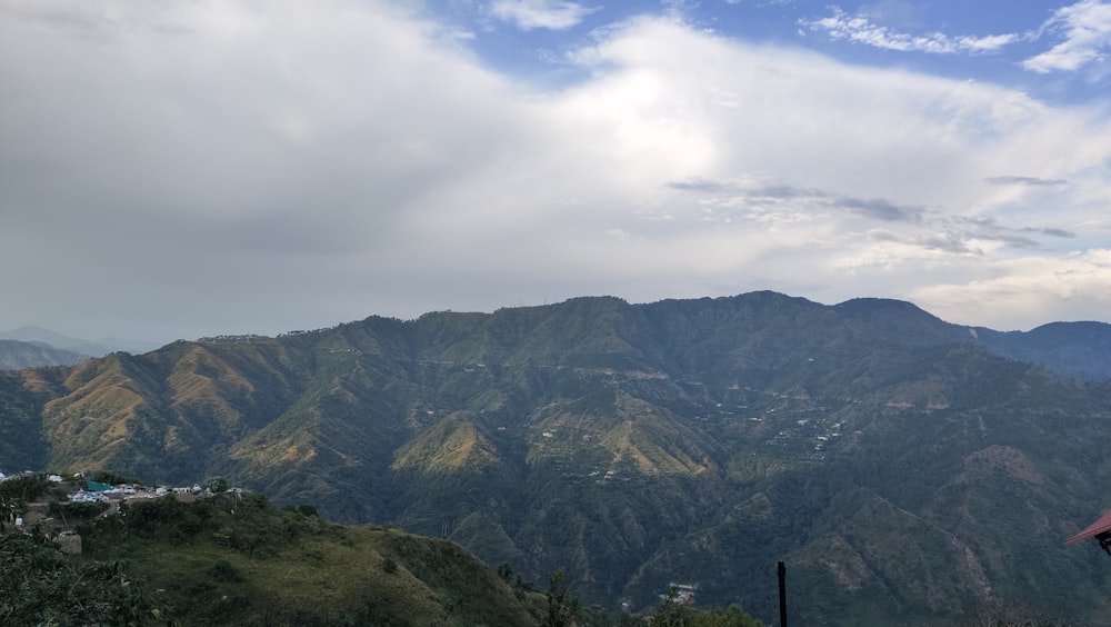 green and brown mountains under white clouds during daytime