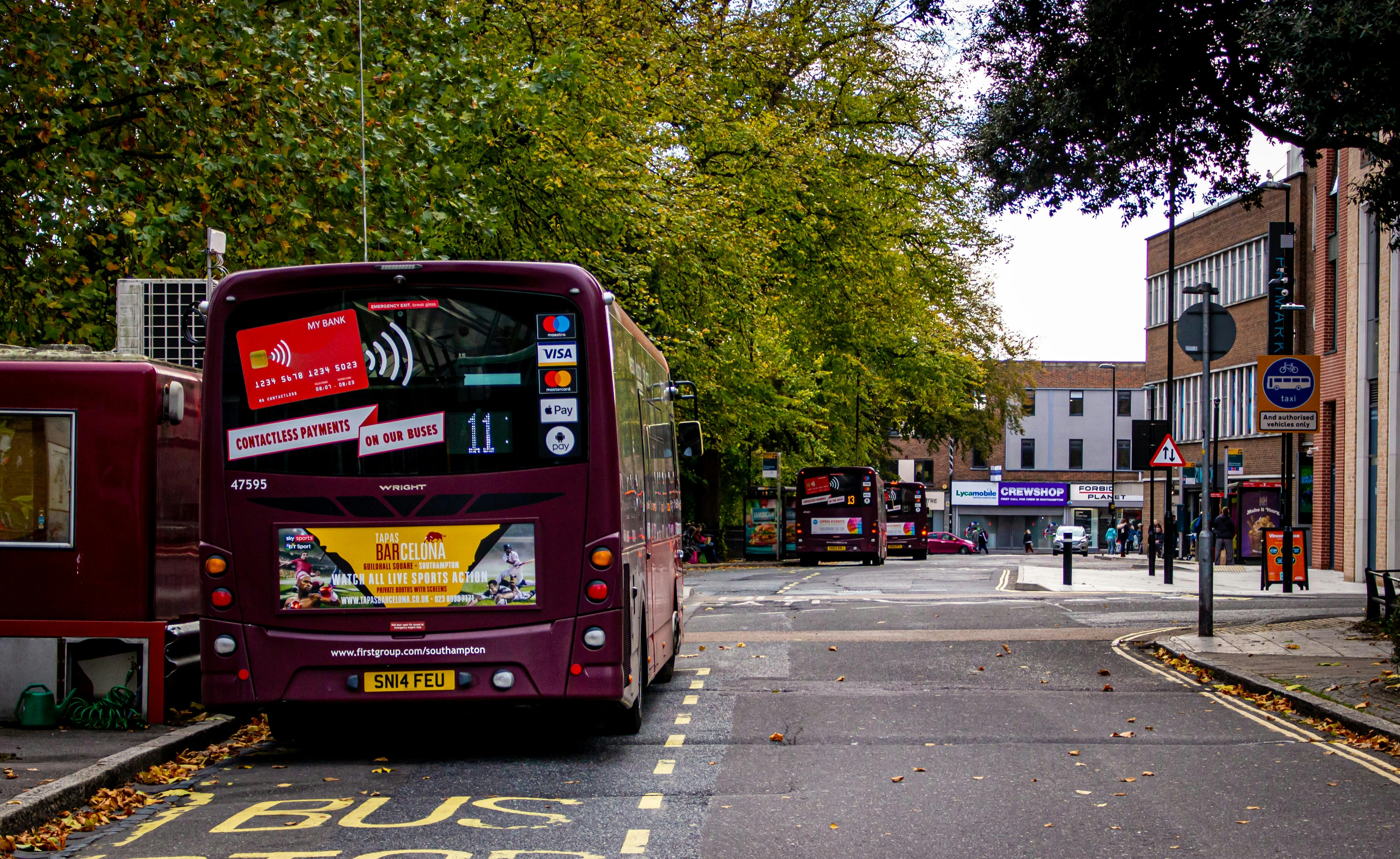 red and black bus on road during daytime
