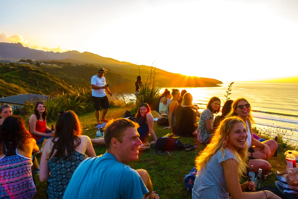 people sitting on grass field during daytime