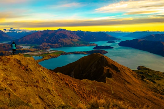 brown mountain near body of water during daytime in Roys Peak New Zealand