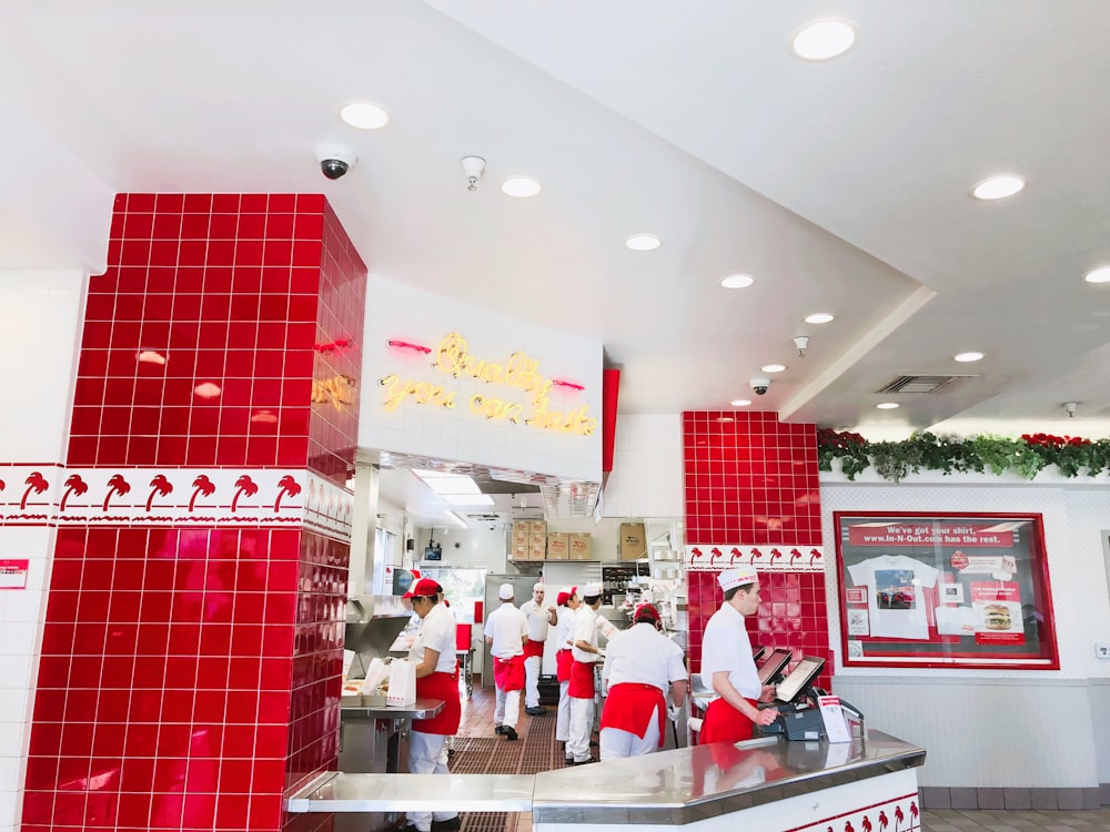 people in white and red kitchen