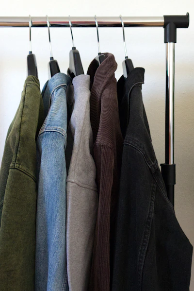 black and gray jackets on white wooden cabinet