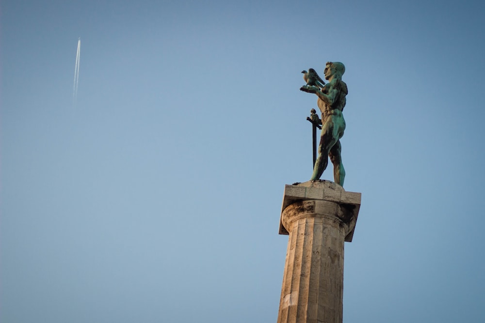 man riding horse statue under blue sky during daytime