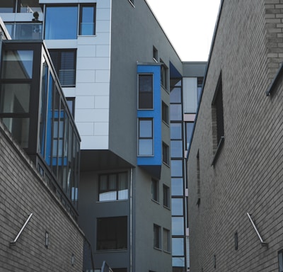 gray concrete building with blue windows