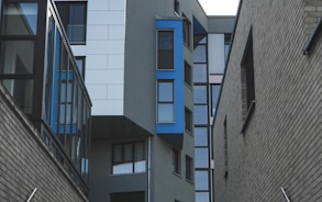 gray concrete building with blue windows