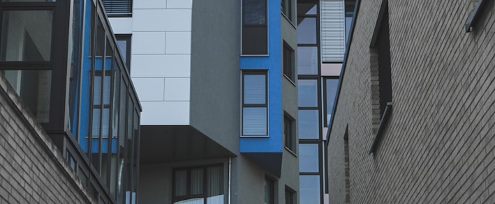 gray concrete building with blue windows