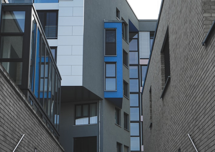 gray concrete building with blue windows