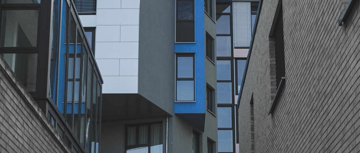 gray concrete building with blue windows