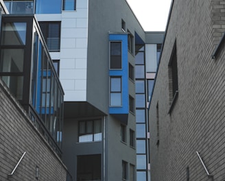 gray concrete building with blue windows