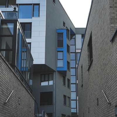 gray concrete building with blue windows