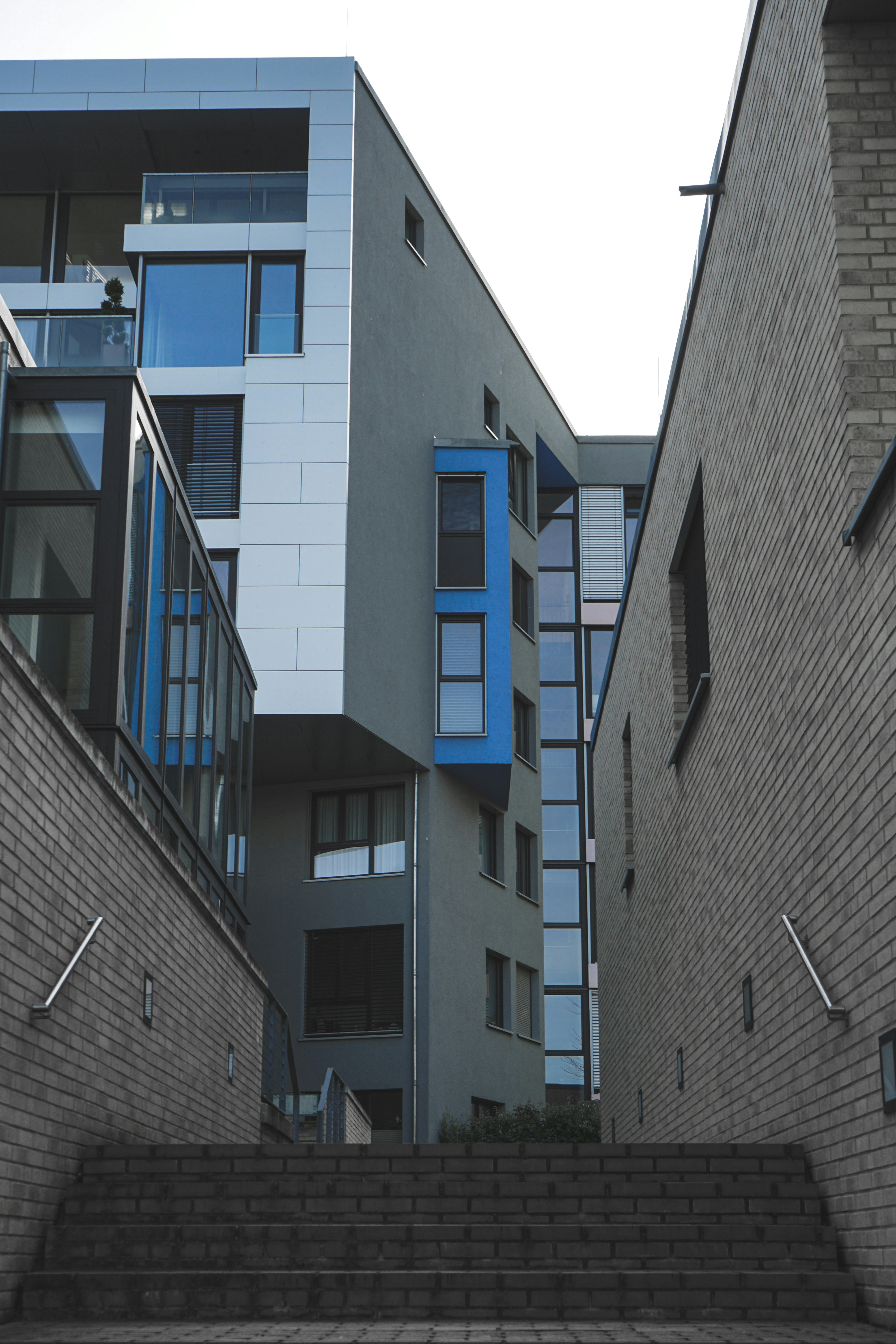 gray concrete building with blue windows