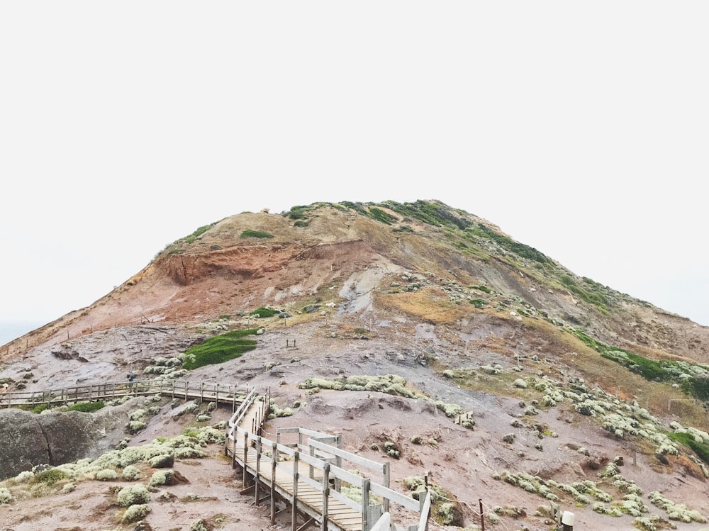 brown wooden fence on brown rock mountain during daytime