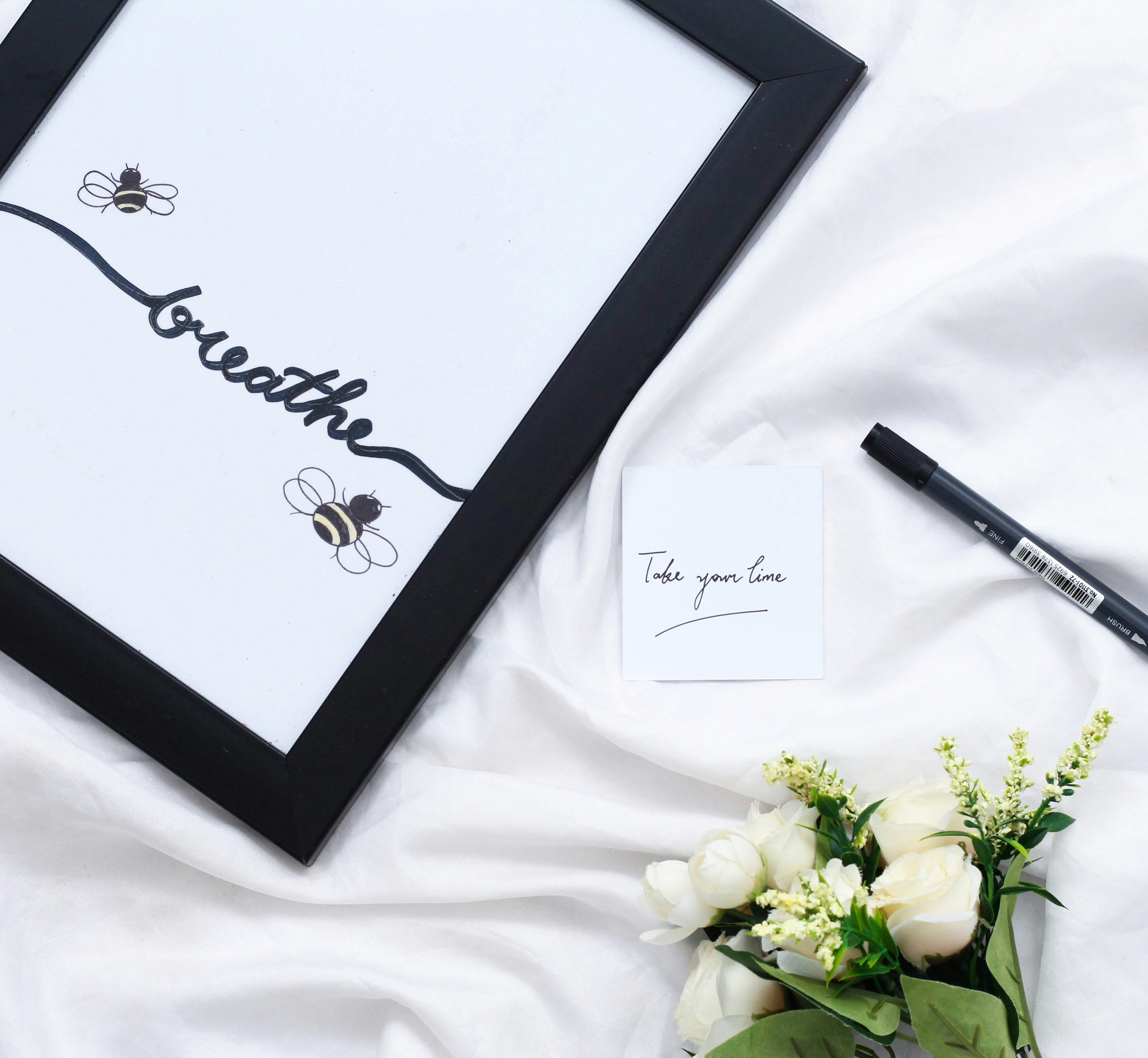 black wooden frame with white flower