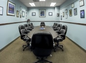 black office rolling chairs on brown carpet