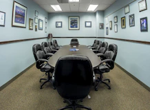 black office rolling chairs on brown carpet