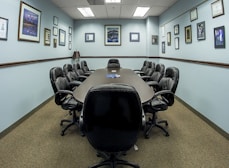 black office rolling chairs on brown carpet