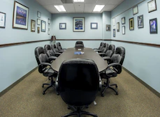 black office rolling chairs on brown carpet