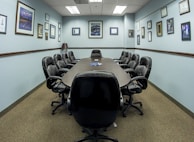 black office rolling chairs on brown carpet