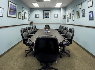 black office rolling chairs on brown carpet