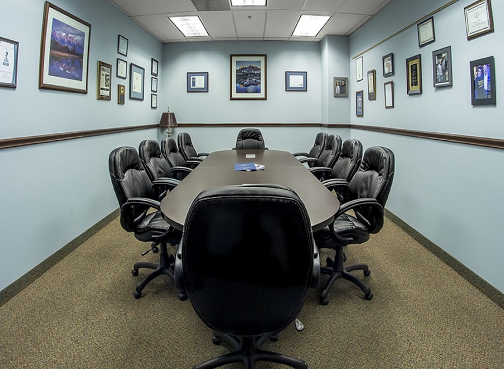 black office rolling chairs on brown carpet