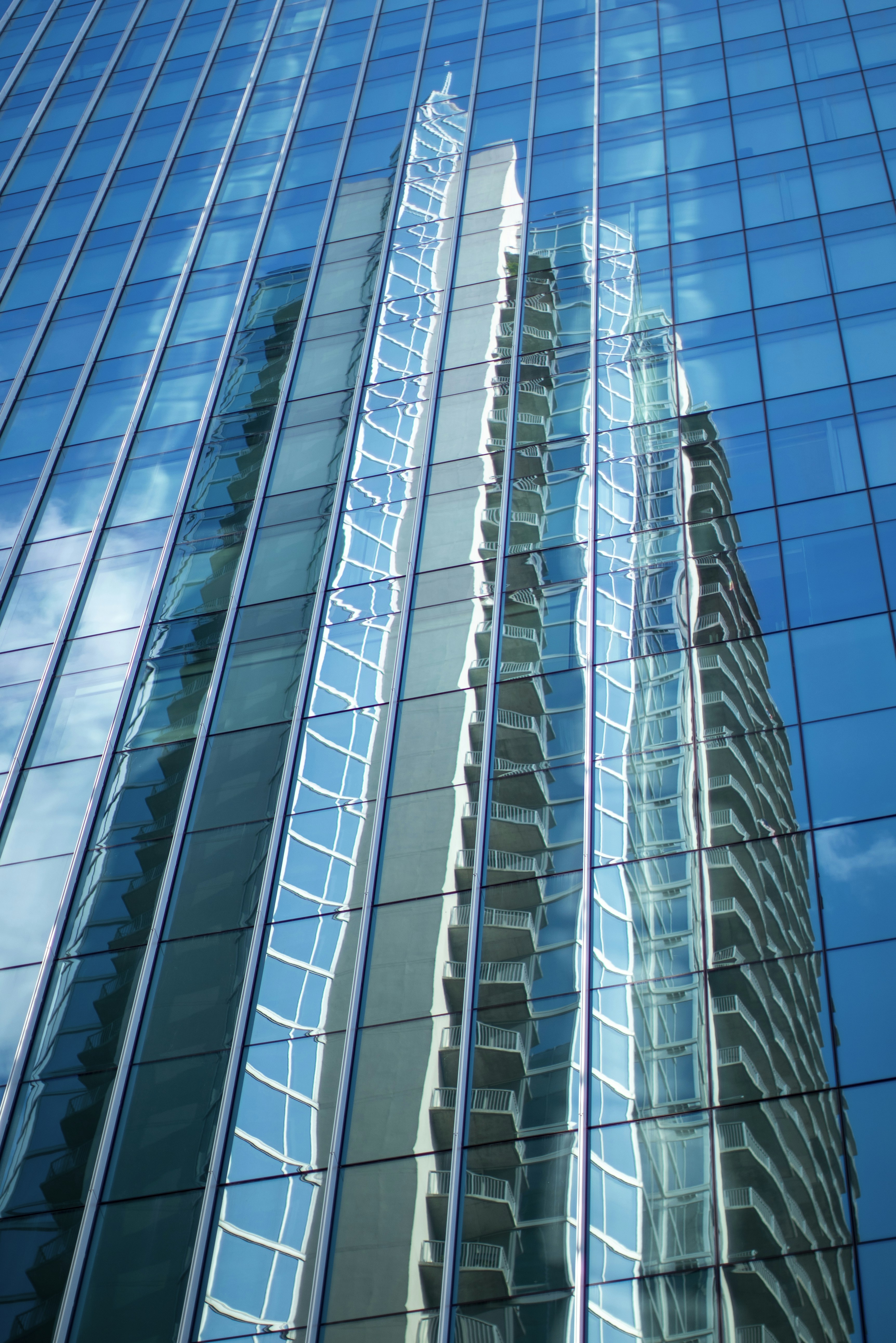 white and blue glass walled high rise building