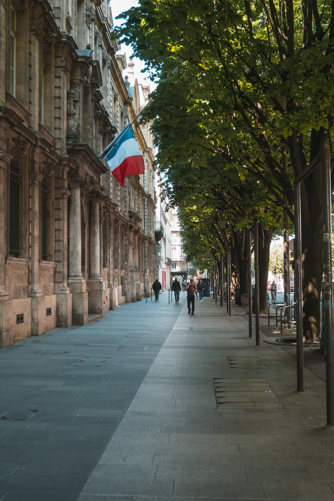 people walking on sidewalk near building during daytime