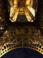 Night view of a completed metallic structure illuminated by construction lights, reflecting craftsmanship.