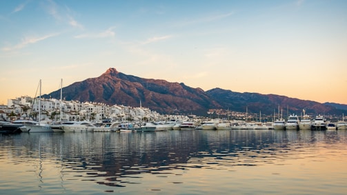 white boats on sea near mountain during daytime