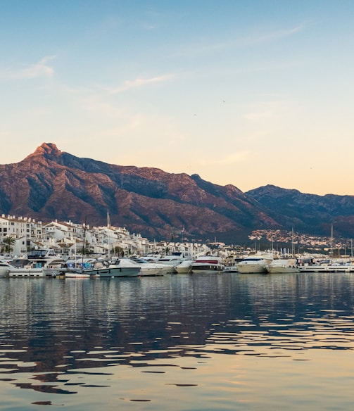 white boats on sea near mountain during daytime