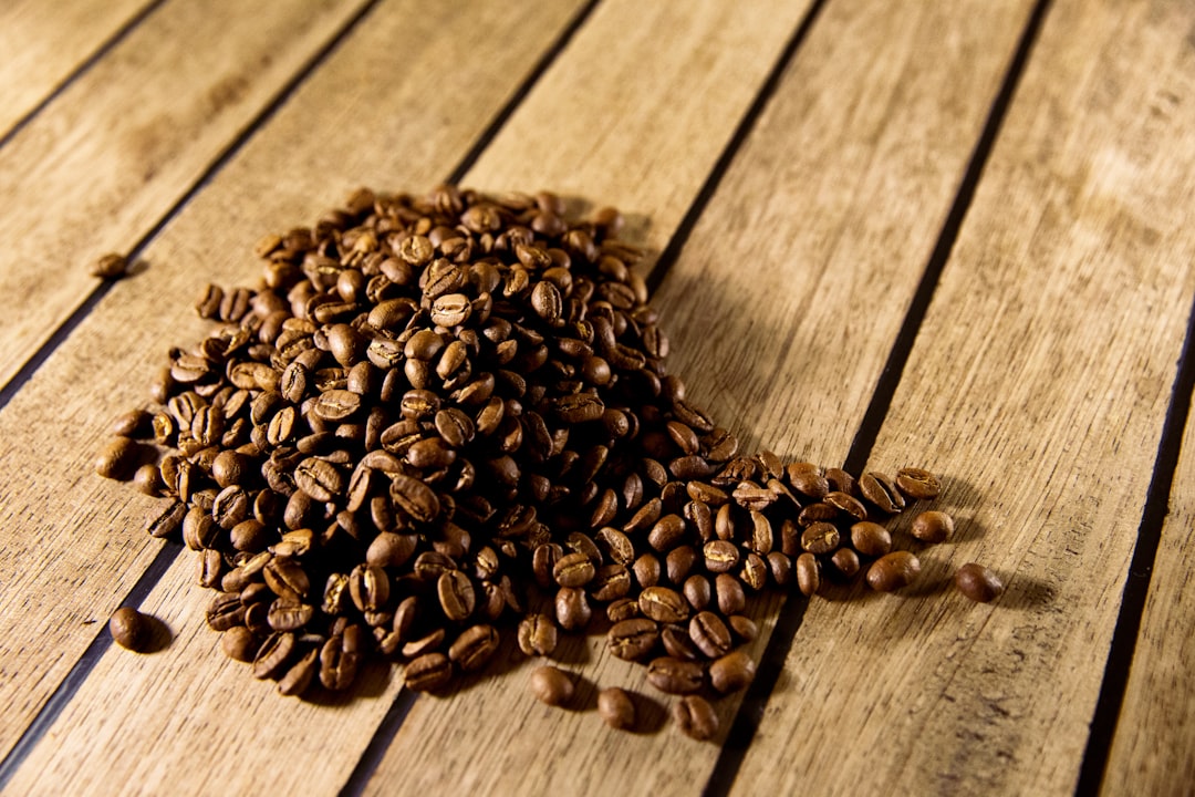 brown coffee beans on brown wooden plank